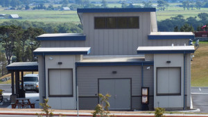 front of a building with blue roofing